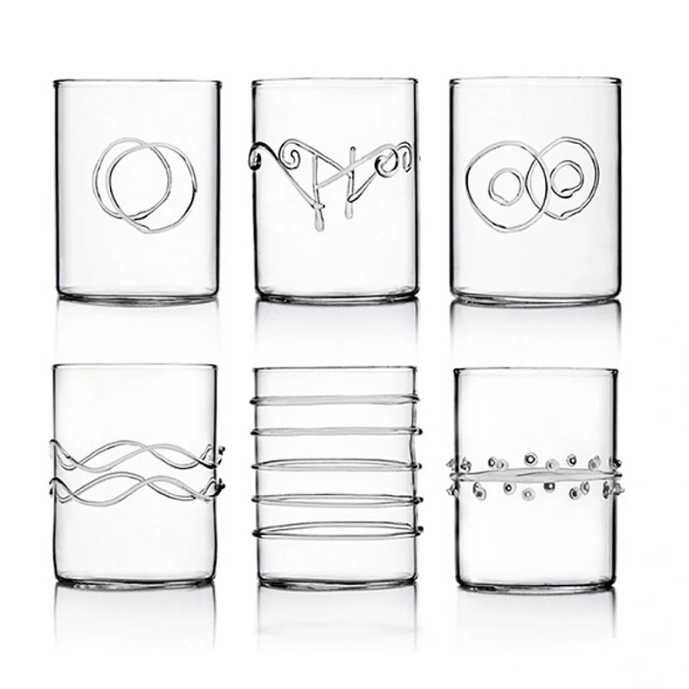 Six Deco Clear Water Glasses by Ichendorf Milano, each made from sturdy borosilicate glass and adorned with distinctive raised patterns—such as loops, waves, rings, parallel lines, and dots—are arranged in two rows on a plain white background.
