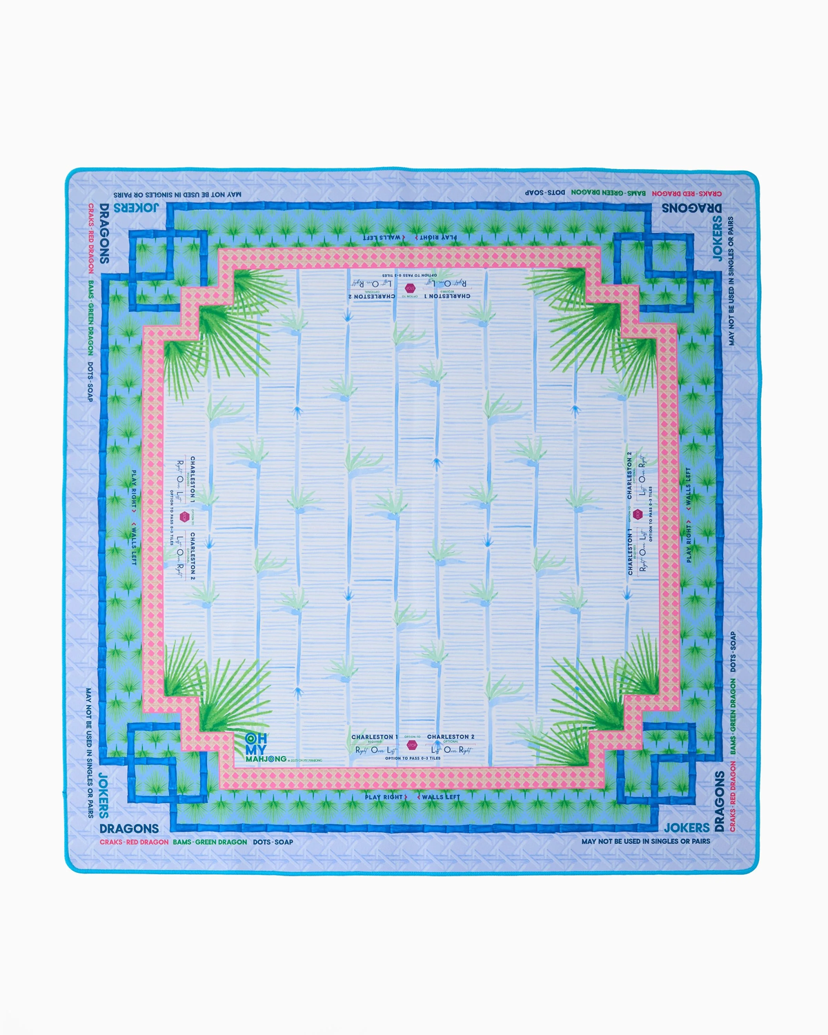 Oh My Mahjong’s “Mahjong Mats -” square scarf features light blue vertical lines, central green palm trees, geometric blue and pink borders, and “JOKERS” and “DRAGONS” printed along the edges.