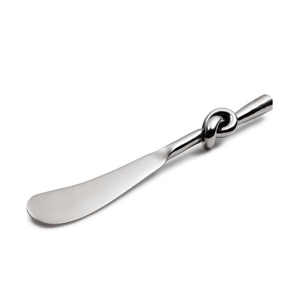 The Mary Jurek Helyx Stainless Steel Canape Spreader, featuring a knot design in the handle, is displayed on a white background.