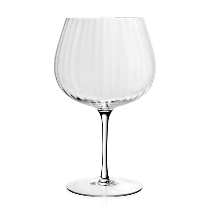 The Corinne Drinkware by William Yeoward: a clear, empty wine glass with a wide rounded bowl, thin stem, and flat base set on a plain white background—an elegant piece of contemporary barware.