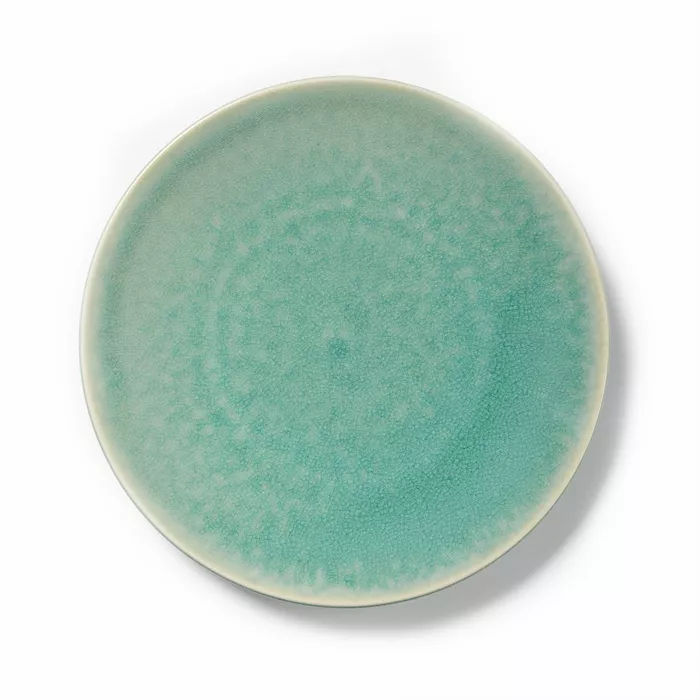 The Tourron Dinnerware Jade by Jars - Rosenthal is a round ceramic plate with a textured turquoise glaze, pale rim, and subtle color variations. Its speckled surface gives it a timeless, watercolor-like look for your table.