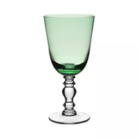 The William Yeoward Fanny Colored Country Goblet 13 oz. is a green wine glass with a transparent, ornate stem and base—adding elegance and a classic touch to any table setting. Perfect for those who appreciate colored goblets.