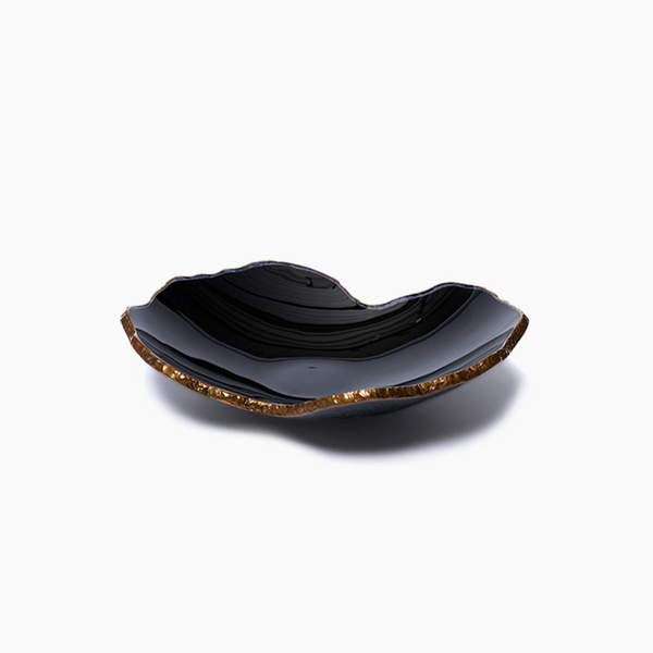 The Gardeco Mapa Bowl Black & Bronze Trim - Mini is a shallow, wavy-edged handcrafted black bowl with a glossy finish and textured bronze rim, shown against a plain white background—an exquisite decorative art piece.