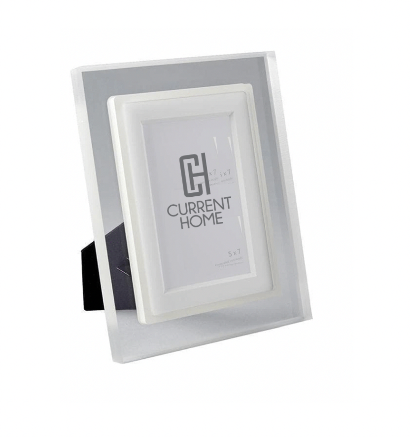 The Prisma Frame Lip - Eggshell by Bella Moulding is a white and silver freestanding acrylic photo frame with a black stand, offering modern protection and elegant display for your 5x7 photos.