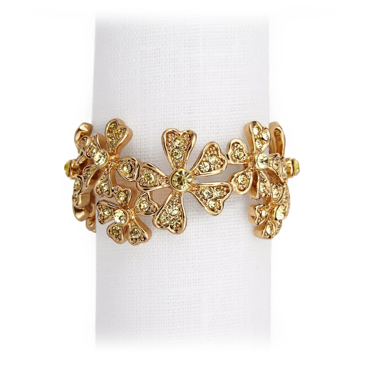A 24K gold plated ring by L’Objet, featuring intricate floral designs with sparkling yellow gemstones, complements the Garland Napkin Jewels Gold Set of 4—ideal for pairing or gifting in a luxury box.