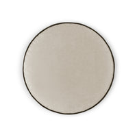 The Posh Circle Pillow 18″D - by D.V. KAP / Canaan Company is a modern round, light beige cushion with a dark brown border, shown from above on a white background.