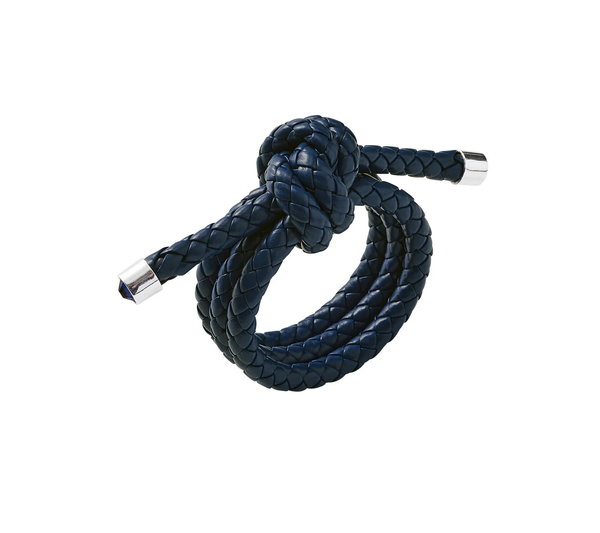 The Rope Knot Napkin Ring Set of 4 by Kim Seybert features dark blue faux leather in a braided design with rope knot detail and silver hardware, inspired by coastal style.
