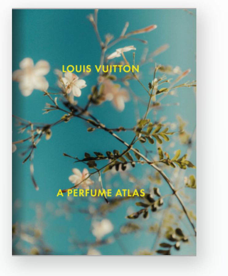 A book cover with white flowers and green branches on blue, with yellow text "Louis Vuitton: A Perfume Atlas" by W.W. Norton Company—a guide to unique fragrance ingredients in perfumery.