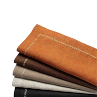 The Kim Seybert Classic Napkin - Earthtones Set of 4 features elegant embroidered linen napkins in orange, brown, beige, and gray with detailed borders—perfect for adding style to your table decor.