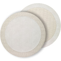 Two round Bodrum Halo placemats from the Neutrals set overlap, each reversible with a plain center and woven-pattern border—one in light beige, one in off-white—perfect for modern tables. Set includes 4 placemats.