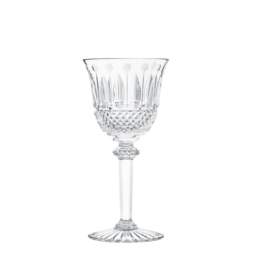 The Saint-Louis Tommy Stemware, featuring a decorative bowl, long stem, and fluted base in intricately cut crystal, is displayed against a plain white background.