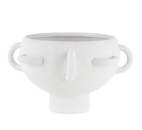 The BT-Shalom Textured Vessel White is a white porcelain piece with abstract facial features, multiple handles, and a short cylindrical base.