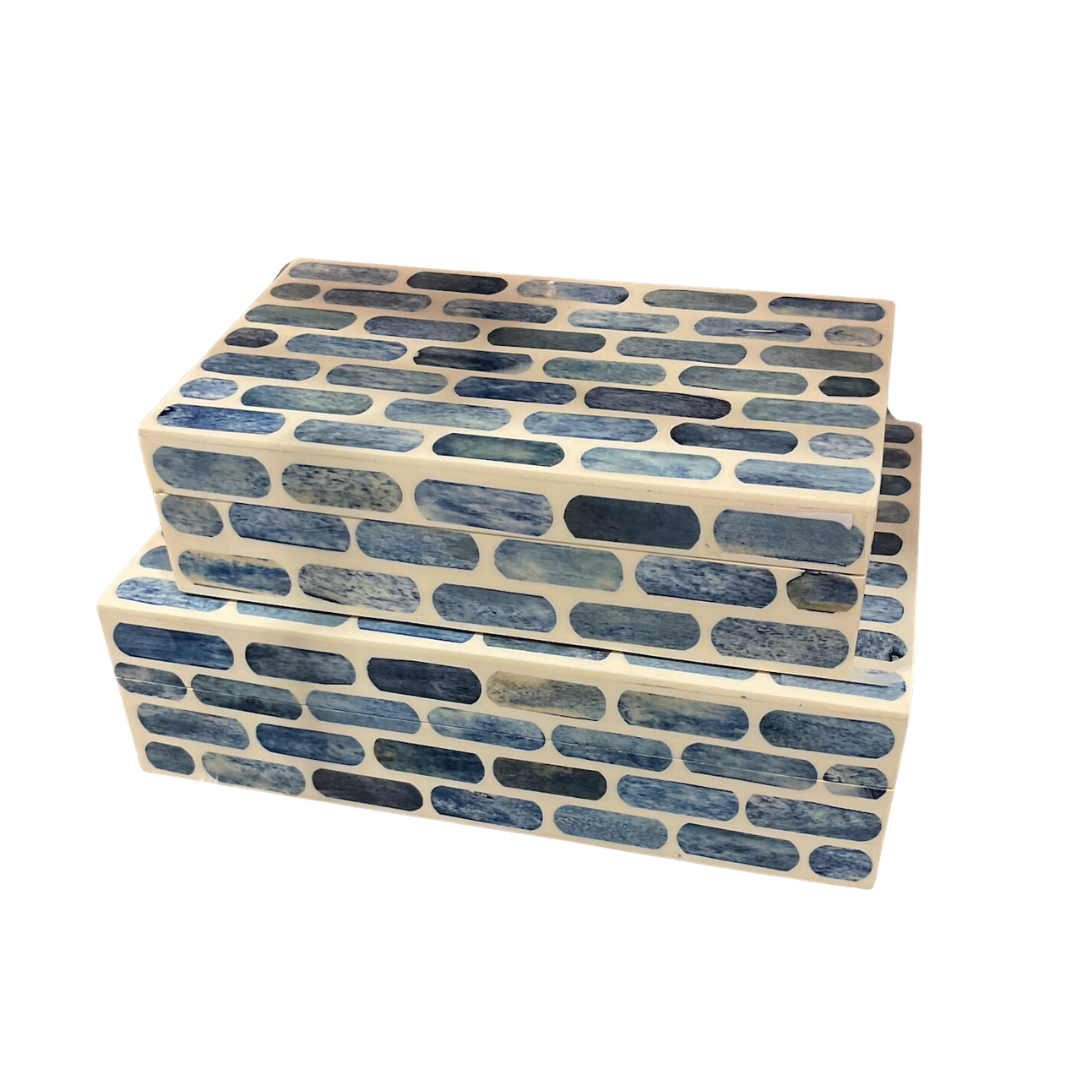 Two Blue Step Bone Boxes by A Sanoma Inc, handcrafted in the Himalayas, stacked together. Both feature a cream base with blue brick-like patterns formed by elongated rounded rectangles.