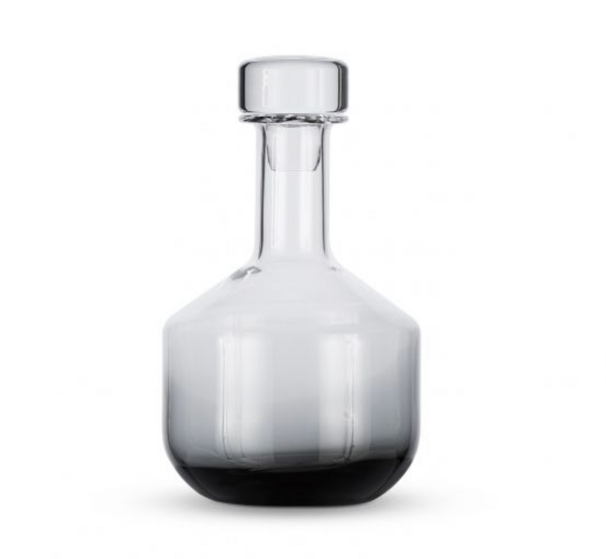The Tom Dixon Tank Black Whiskey Decanter is a handmade, mouth-blown glass decanter with a clear wide base, narrow neck, and round glass stopper, displayed against a plain white background.