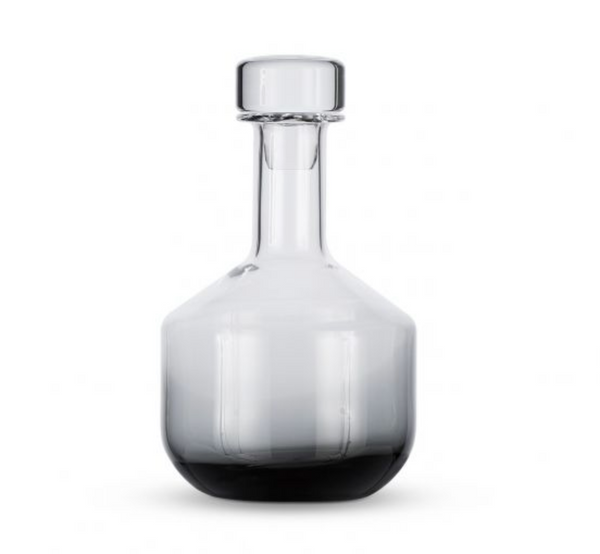 The Tom Dixon Tank Black Whiskey Decanter is a handmade, mouth-blown glass decanter with a clear wide base, narrow neck, and round glass stopper, displayed against a plain white background.