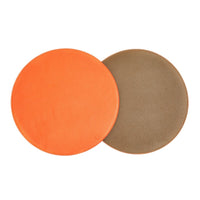 Four reversible placemats by Von Gern Home, shown in bright orange and tan, are arranged side-by-side on a white background for an elegant table setting.