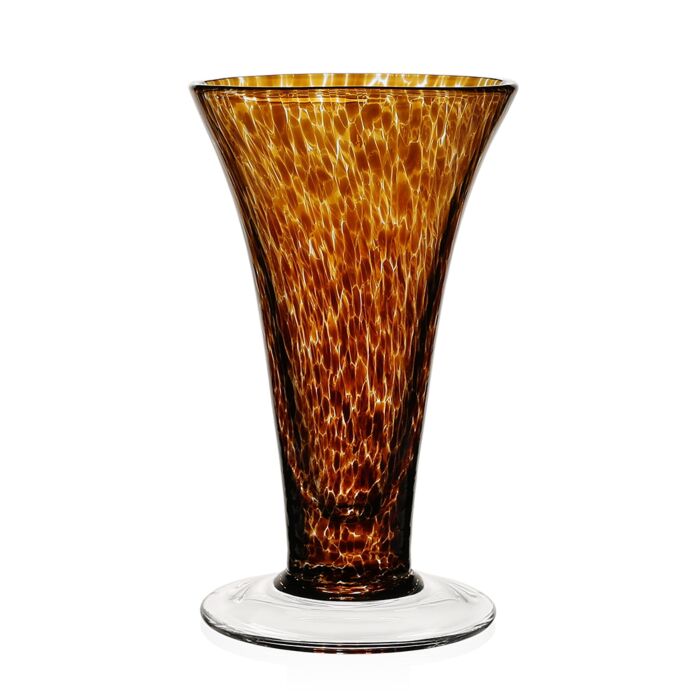 The Vanessa Vase - Tortoise by William Yeoward is a tall, flared glass vase with a wide base, narrow neck, and a mottled amber-brown pattern. Its clear base contrasts beautifully with the richly textured Mediterranean-inspired design.