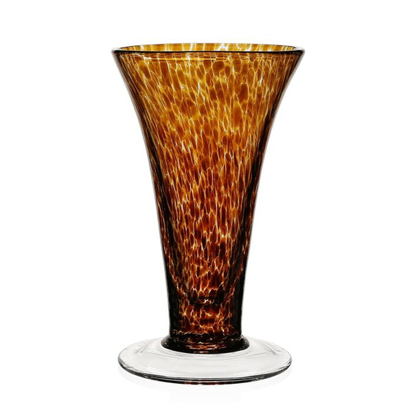 The Vanessa Vase - Tortoise by William Yeoward is a tall, flared glass vase with a wide base, narrow neck, and a mottled amber-brown pattern. Its clear base contrasts beautifully with the richly textured Mediterranean-inspired design.