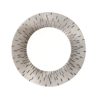 A round mirror with a wide, textured frame of radiating black lines on light recalls the artistry of Haviland’s Infini Prestige Platinum Dinnerware, inspired by hand-painted plates from the renowned Limoges porcelain collection.