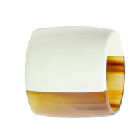 The Von Gern Home Horn Napkin Ring Set of 4 features wide, square-edged rings crafted from natural horn with a smooth surface and a chic half-white, half-amber brown color block design.