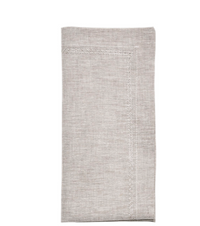 The Kim Seybert Classic Napkin - Earthtones Set of 4 features light beige linen with decorative edge stitching, ideal for adding an elegant touch to any tablescape. Displayed on a white background, these napkins enhance any dining setting.