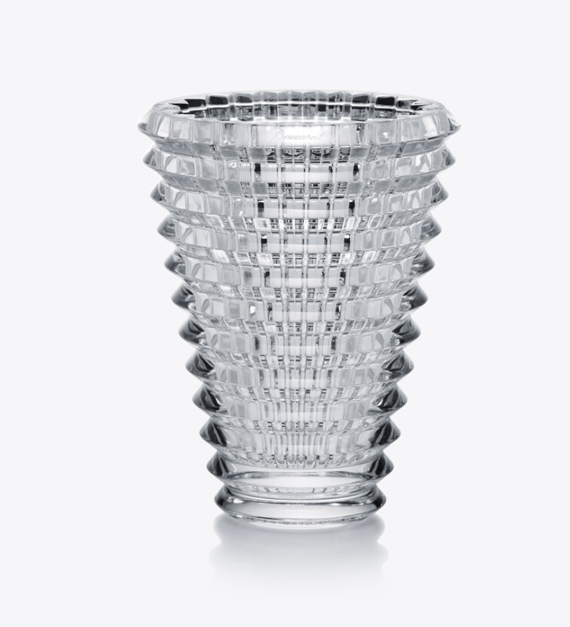 The Baccarat Eye Oval Vase is a clear, textured crystal piece with a wide top and narrow base, showcasing a geometric pattern of layered horizontal and vertical bevel cuts.