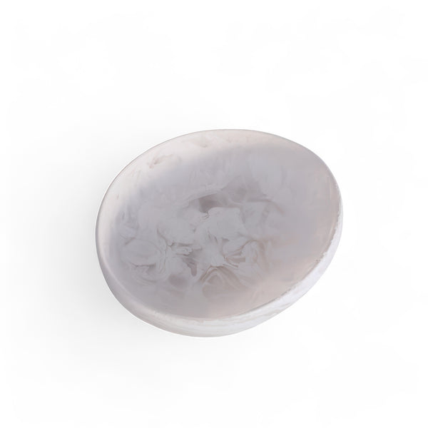 The Arila Small Bowl - White Swirl by Nashi Home features a translucent, round design with a white swirl marbled pattern—perfect for coastal décor. Photographed on a white background.
