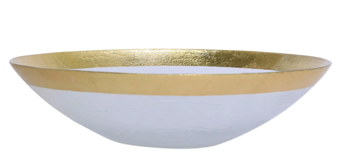 The Vietri Rufolo Glass Dinnerware Gold is a shallow, round white bowl with a smooth surface and gold metallic rim, evoking Italian style and perfect for glamorous tableware settings. Styled like the Rufolo Glass Charger on a plain white background.