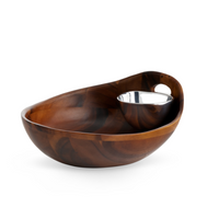 The Nambe Portables Chip & Dip features a polished acacia wood serving bowl with an attached Nambé Alloy dip bowl at the rim, ideal for snacks and dips, displayed against a white background.