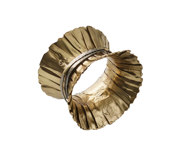 The Kim Seybert Clinched Napkin Ring in Gold & Silver, Set of 4, features ruffled leaf-like edges and a twisted, textured band reminiscent of modern table décor.