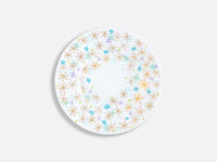 The Bernardaud Fèerie by Michael Cailloux dinner plate features a round white design with colorful gold, blue, and purple star-shaped flowers around the rim and a mostly blank center—a striking piece from the collection.