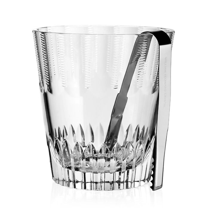 The Karen Ice Bucket by William Yeoward features elegant vertical cut patterns, intricate lower detailing, and comes with silver metal tongs—a timeless crystal glass accessory for any refined bar setting.