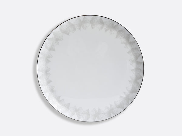 The Bernardaud Silva Dinnerware Serving Piece features a round white plate with a subtle gray geometric pattern and platinum relief on the rim, finished by a thin dark edge—an elegant addition to any table.