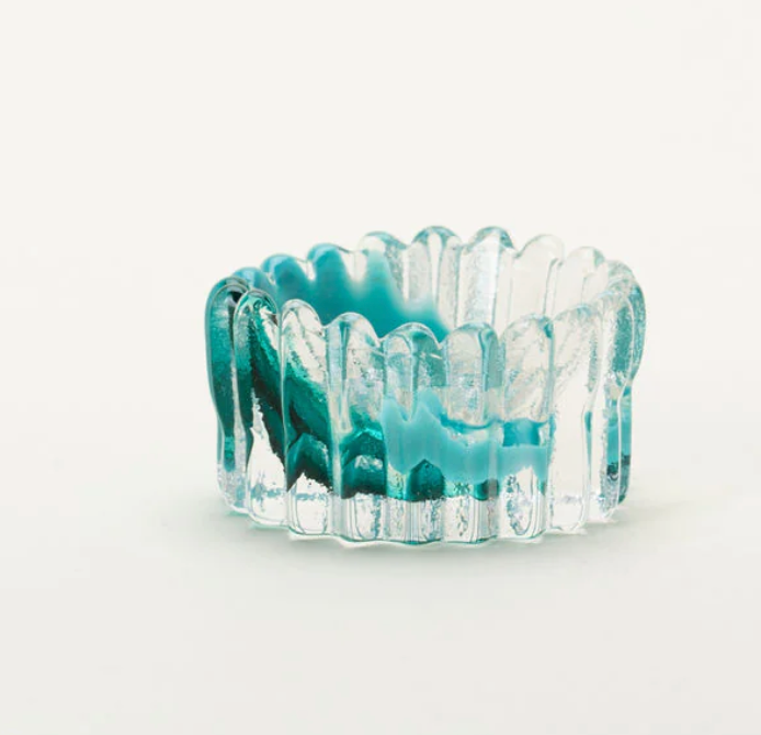 The Splash Catchall Bowl by Gary Bodker is a small, round, handcrafted glass dish in clear and turquoise blue with ribbed texture and wavy edges, displayed on a plain white background.