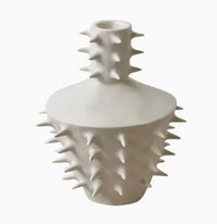 The Spikes Vase III - White by OWO Ceramics is a handmade ceramic vase with a matte white finish, featuring multiple evenly spaced, pointed spikes covering its surface and neck, making it a standout piece of unique home decor against a plain white background.