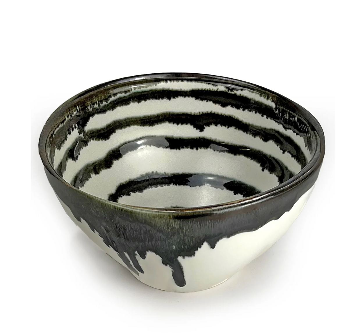 The Michael Wainwright Linea Dip Bowl is a ceramic bowl with a glossy black and white striped design and black glaze drips on the rim and exterior, shown against a plain white background.