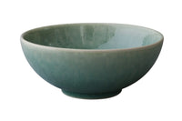 The Jars - Rosenthal Tourron Dinnerware Jade is a round, ceramic bowl with a smooth, glossy greenish-blue gradient, offering timeless style against a white background.