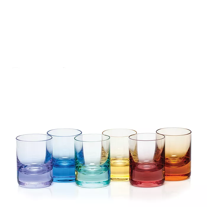 Six Moser Whiskey Spirit Glasses in purple, blue, light blue, green, yellow, and orange—a colorful translucent set arranged in a row against a white background.