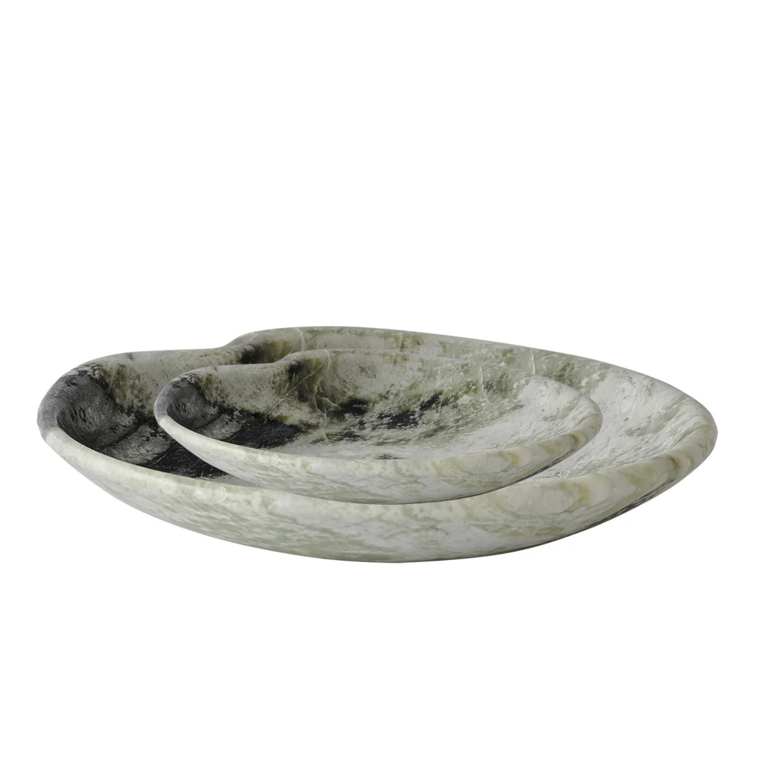 The Lily Marble Bowl Irish Green by Greg Natale features a shallow, oval shape with wavy, organic design and distinctive marbled green patterns—perfect as biomorphic decor.