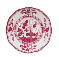 The Beatriz Ball Faenza Melamine Dinnerware Deep Pink - Set of 4 features a scalloped edge and intricate red floral and geometric designs on white, inspired by classic Italian ceramics.