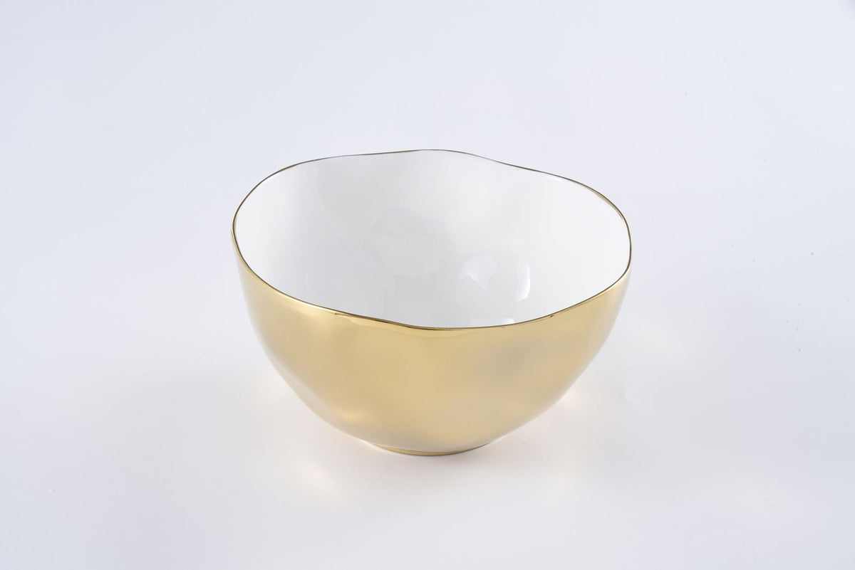 The Moonlight Bowl by PAMPA BAY is a round porcelain serving bowl with a glossy gold exterior, white interior, and an organically shaped rim finished in gold titanium, displayed against a plain white background.