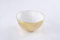 The Moonlight Bowl by PAMPA BAY is a round porcelain serving bowl with a glossy gold exterior, white interior, and an organically shaped rim finished in gold titanium, displayed against a plain white background.