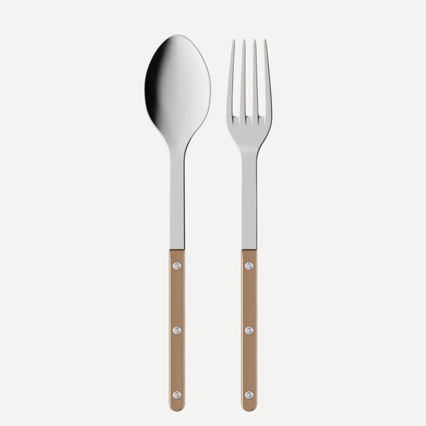 The Sabre Bistrot Pearly Serving Set includes a metal spoon and fork with customizable brown handles, each featuring three silver rivets, displayed side by side against a white background.