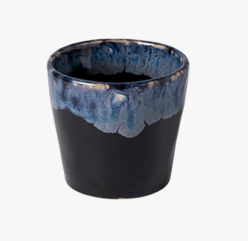 The Costa Nova Lungo Cup Grespresso- Black is a ceramic cup made in Portugal, featuring a matte black base, glossy blue and white glazed rim, smooth rounded shape, and slightly flared opening.