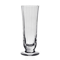 The Corinne Drinkware by William Yeoward is a clear, tall fluted glass vase with a wide base and slightly flared rim, inspired by contemporary barware and shown against a plain white background.