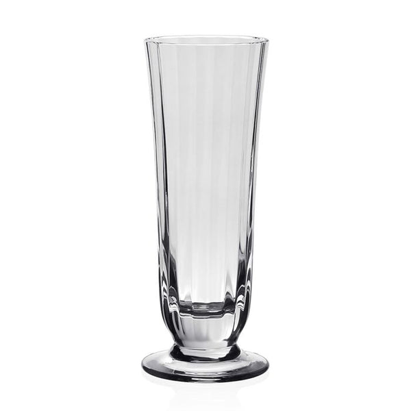 The Corinne Drinkware by William Yeoward is a clear, tall fluted glass vase with a wide base and slightly flared rim, inspired by contemporary barware and shown against a plain white background.