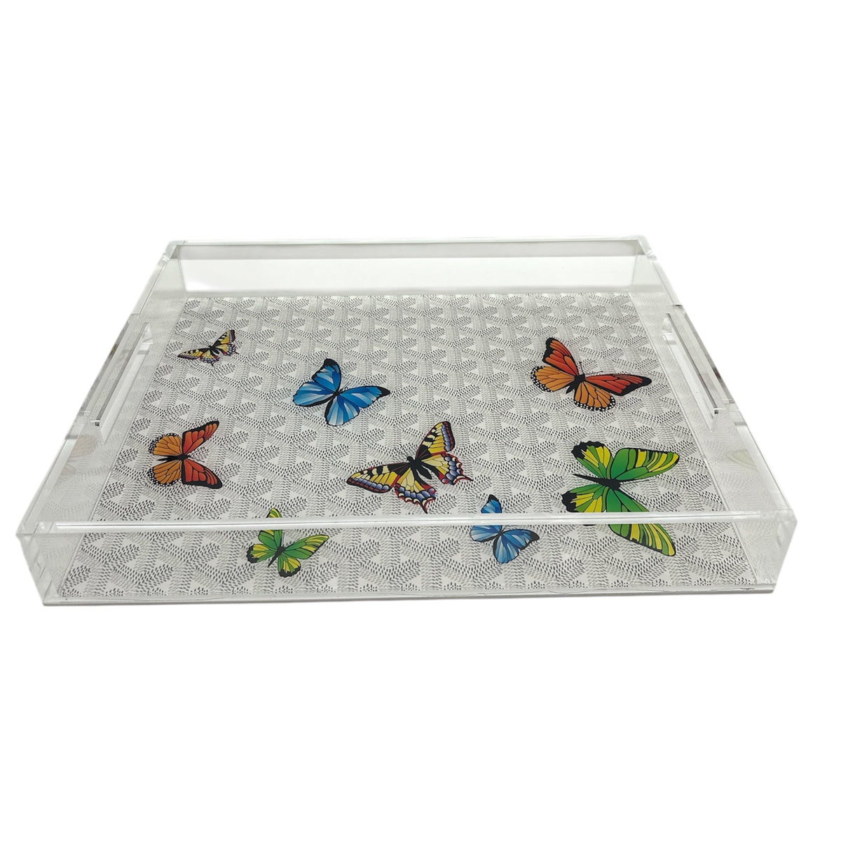 The Grandeur Tray - Maison Grey w/ Butterflies 14 x 18 by Eye Candy is a clear acrylic tray with side handles, featuring a patterned grey base decorated with colorful butterflies in blue, green, orange, and yellow.