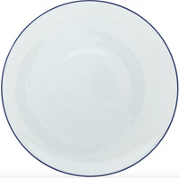 The Monceau Bleu Outremer Dinnerware by Raynaud features a plain, round white Limoges porcelain plate with a thin ultramarine blue rim, photographed from above against a white background.