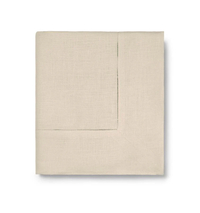 The Sferra Festival Tablecloth is shown neatly folded with a subtle stitched border, displayed against a white background.