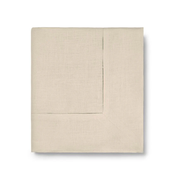 The Sferra Festival Tablecloth is shown neatly folded with a subtle stitched border, displayed against a white background.